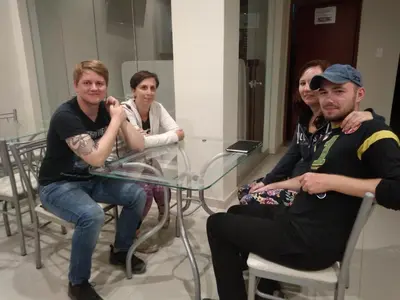 a group of people sitting around a glass table at PiscoMar Peru in Pisco