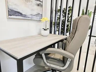 a table and a chair on a balcony at OceanFront Larcomar Apartments in Lima