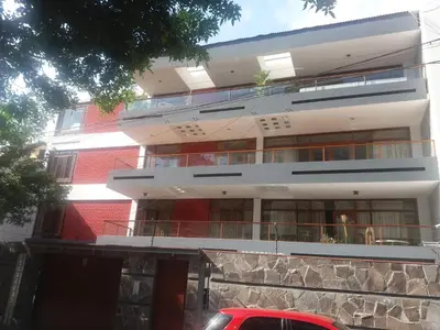 a red brick building with a red car parked in front of it at Miraflores in Lima