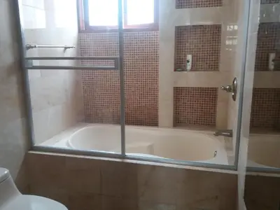 a bathroom with a bath tub with a shower and a toilet at Miraflores in Lima