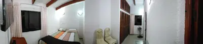 a small room with a bed and shoes in it at Family House in Lima