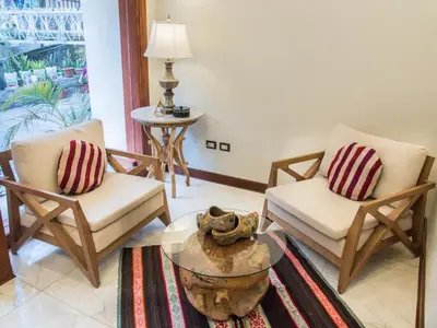 a living room with two chairs and a table at Jaya Machu Picchu Boutique Hotel in Machu Picchu