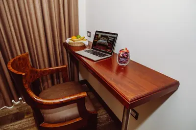 a desk with a laptop and a chair in a room at Jaya Machu Picchu Boutique Hotel in Machu Picchu
