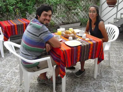 a man and a woman sitting at a table at Kelebek Hostel in Lima