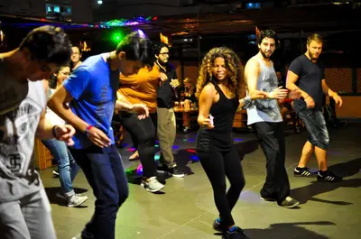 a group of people dancing on a stage at Pariwana Hostel Lima in Lima