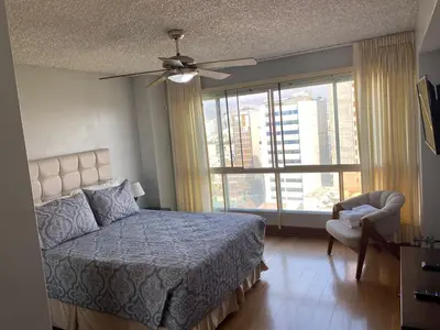 a bedroom with a bed and a ceiling fan at Oceanfront Miraflores Larcomar next to Marriott in Lima