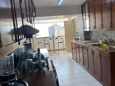a kitchen with a sink and a stove top oven at Oceanfront Miraflores Larcomar next to Marriott in Lima
