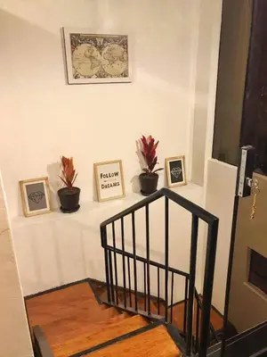 a staircase with three pictures on a white wall at Del Niño Apartment, Best location in Cusco