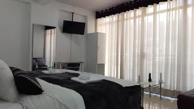 a bedroom with a large bed with a television on it at Hotel Murano in Abancay
