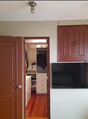 a room with a closet with a door and a mirror at Black Shark Apartments in Lima
