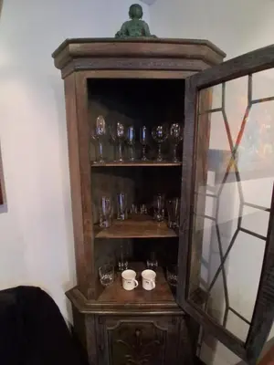a wooden cabinet with glasses in it at Black Shark Apartments in Lima