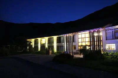a building lit up at night with christmas lights at Taypikala Deluxe Valle Sagrado in Urubamba
