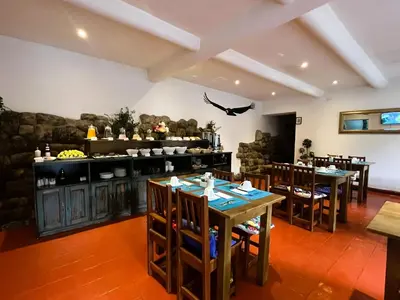 a restaurant with tables and chairs in a room at Usgar San Pedro Boutique in Cusco