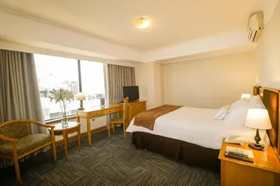 a hotel room with a bed and a desk at Hotel Miramar in Lima