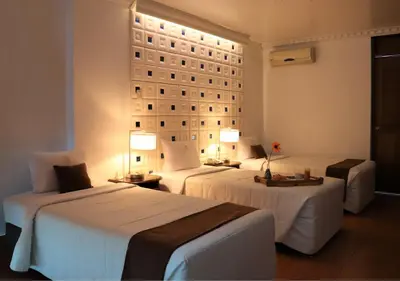 a hotel room with two beds and two tables at Inkari Suites Hotel in Lima