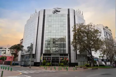 a large white building with a bike on top of it at Hotel Jose Antonio in Lima