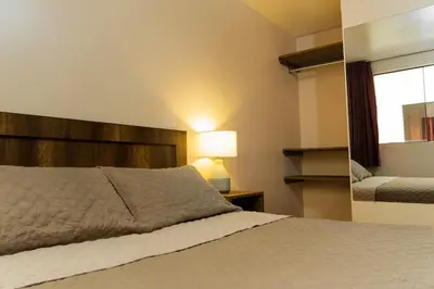 a bedroom with a large bed and a mirror at Montreal Hostal in Lima
