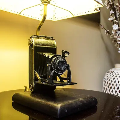 a small camera sitting on a table next to a lamp at Montreal Hostal in Lima