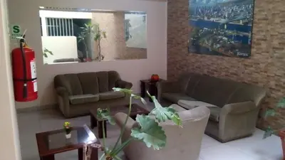 a living room with two couches and a fire hydrant at Montreal Hostal in Lima
