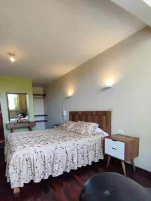 a bedroom with a bed and a wooden floor at Montreal Hostal in Lima