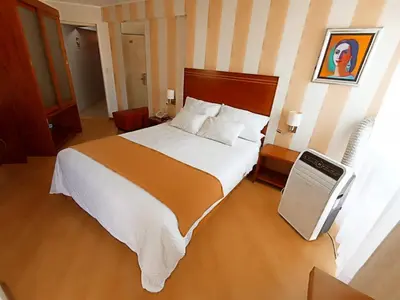 a bedroom with a large bed in a hotel room at Hotel Boutique Runcu Miraflores in Lima