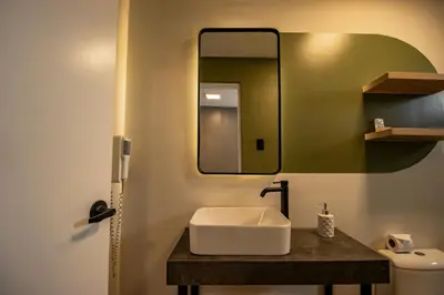 a bathroom with a sink and a mirror at Miraflores Suites Centro in Lima