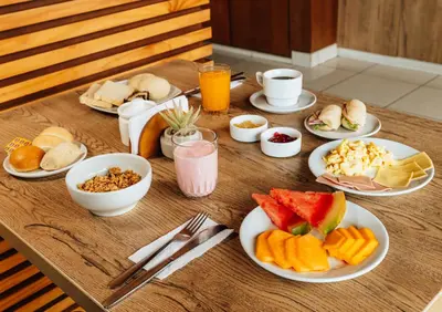 a wooden table with plates of food on it at Miraflores Suites Centro in Lima