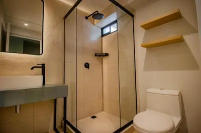 a bathroom with a shower and a toilet and a sink at Miraflores Suites Centro in Lima