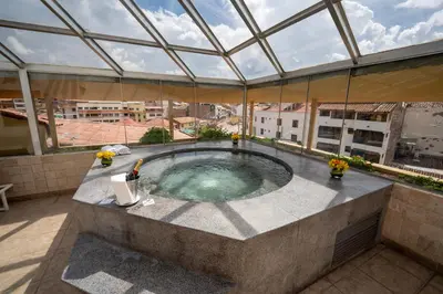 a hot tub on the roof of a building at Hotel Jose Antonio Cusco in Cusco