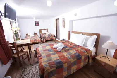 a hotel room with a bed with a stuffed animal on it at Casa Union Cusco in Cusco
