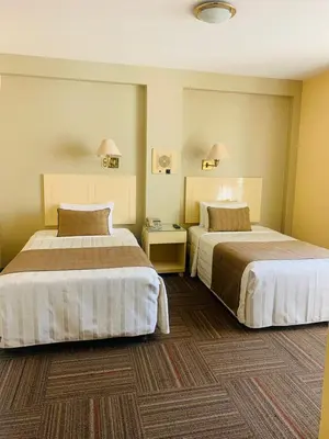 a hotel room with two beds in a room at Embajadores Hotel in Lima