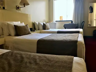 a hotel room with two beds and a window at Embajadores Hotel in Lima