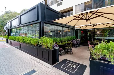 a restaurant with plants on the side of a building at Roosevelt Hotel & Suites in Lima