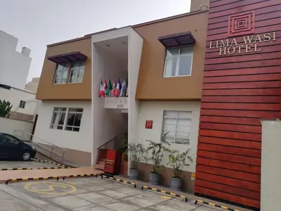a building with a sign for a hotel at Lima Wasi Hotel Miraflores in Lima