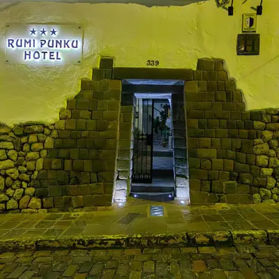 an entrance to a hotel with a yellow building at Hotel Rumi Punku in Cusco