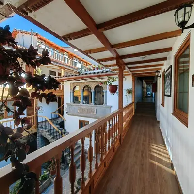 a balcony of a house with wooden railings at Hotel Rumi Punku in Cusco