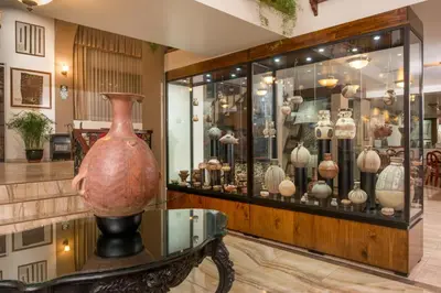 a vase on a table in a display case at Hotel Ruinas in Cusco