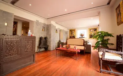 a living room with a couch and a table at Hotel Boutique Gold Garden in Cusco