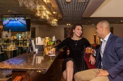 a man and a woman sitting at a bar at Casa Andina Premium Miraflores in Lima