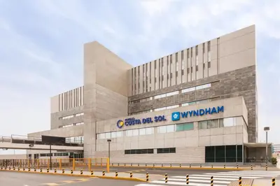 a building with a sign on the side of it at Wyndham Costa del Sol Lima Airport in Lima