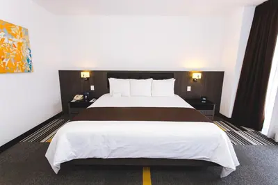 a bedroom with a large bed in a hotel room at Wyndham Costa del Sol Lima Airport in Lima