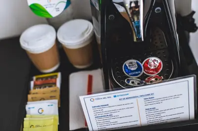 a desk with cups of coffee and a tablet at Wyndham Costa del Sol Lima Airport in Lima