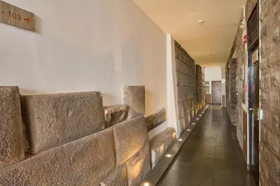 a hallway of a building with stone walls at Casa Andina Standard Cusco Catedral in Cusco