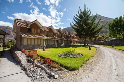 a house on a dirt road next to a garden at Casa Andina Premium Valle Sagrado Hotel & Villas in Urubamba