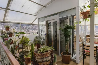 a greenhouse with plants on the roof at Cozy Room Cusco in Cusco