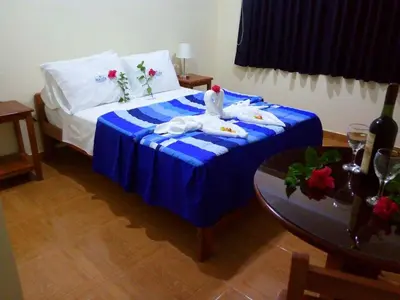 a bedroom with a bed with two swans on it at Maudi Lodging in La Merced