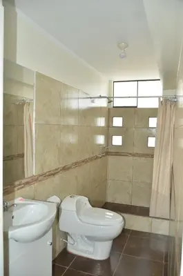 a bathroom with a toilet and a sink at Maudi Lodging in La Merced