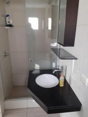 a bathroom with a sink and a shower at Monterrico Suites Hotel in Lima