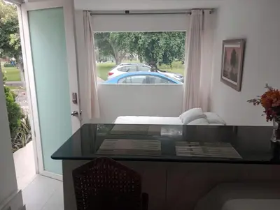 a glass table in a room with a view of a car at Monterrico Suites Hotel in Lima