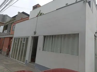 a white facade of a building on a street at Monterrico Suites Hotel in Lima